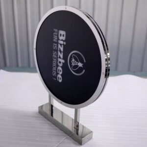 Round illuminated LED logo sign, custom branding, chrome stand — AdsyUp signage Ireland