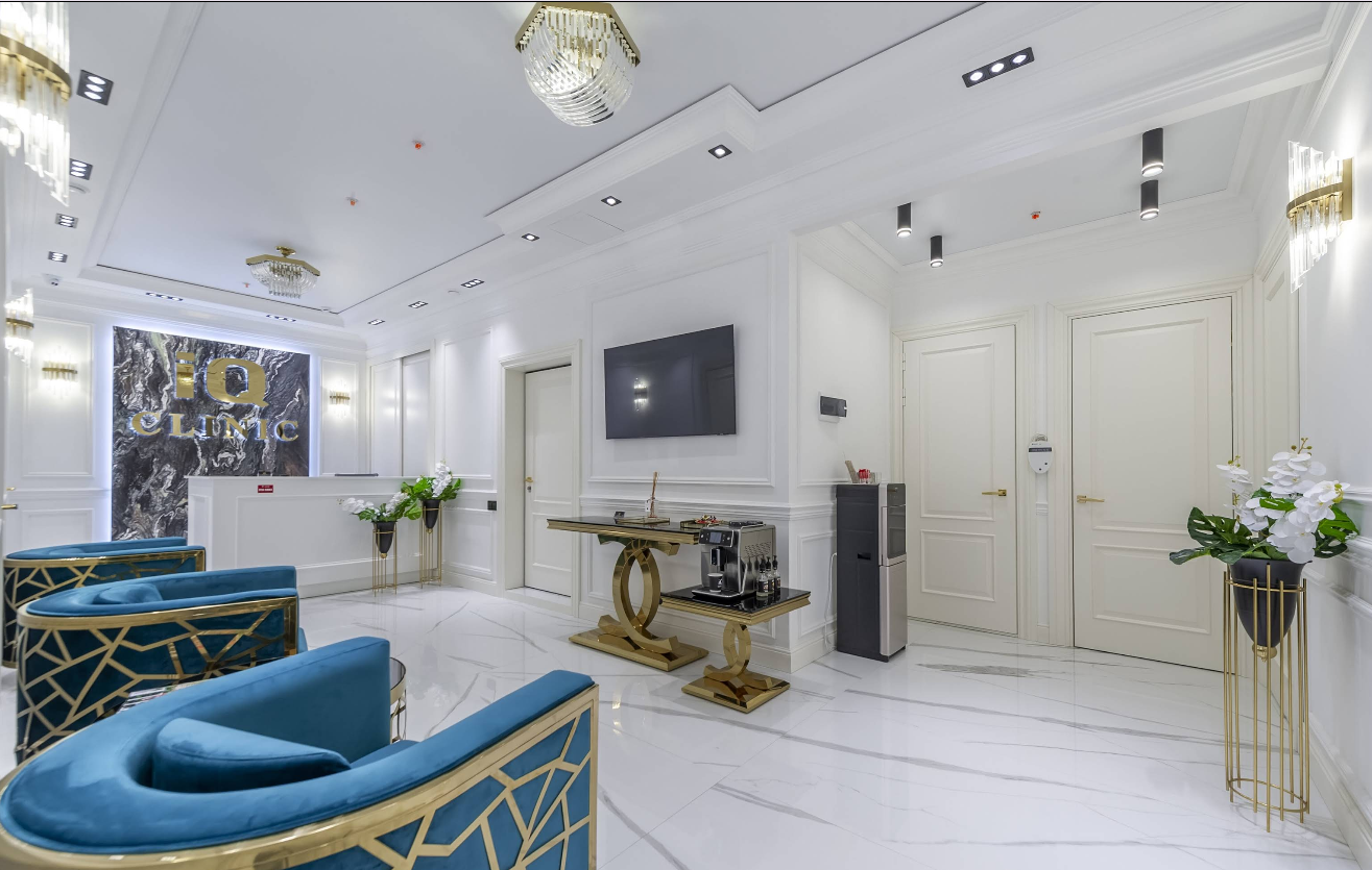 IQ Clinic reception with logo wall and blue armchairs