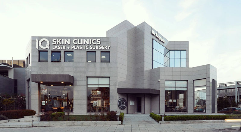 IQ Clinic building exterior with illuminated IQ logo sign on the facade