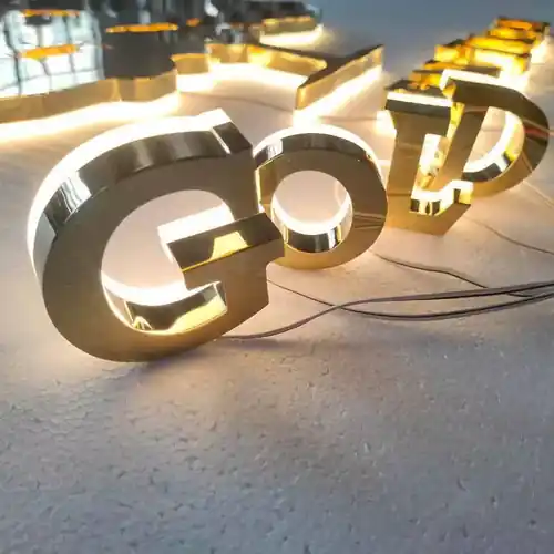 Gold mirror halo-lit 3D logo letters glowing warm white, made by AdsyUp