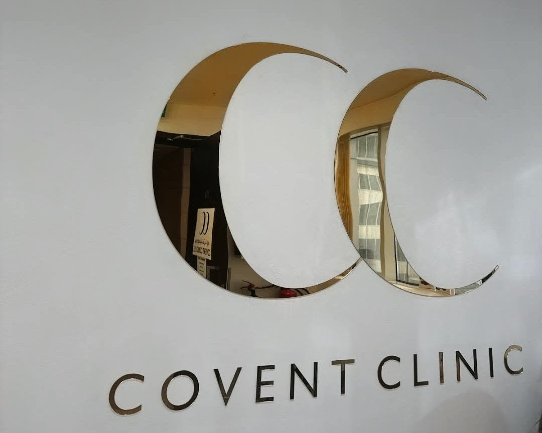 Close view of the mirror gold CC logo and COVENT CLINIC letters