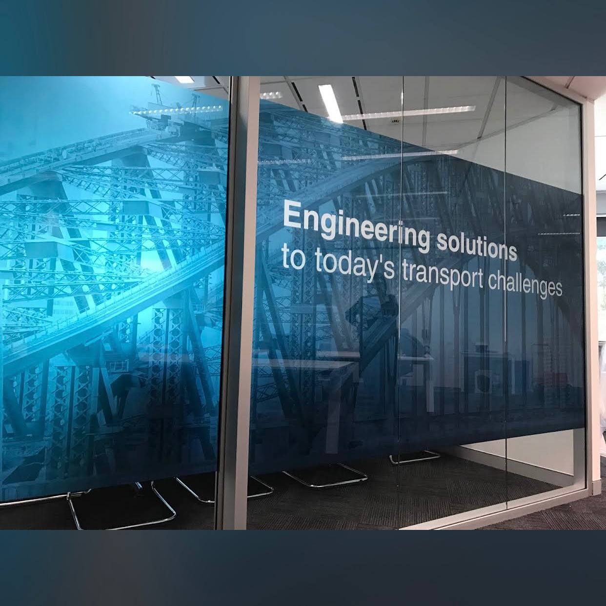 Blue frosted film with graphics and text on a glass wall