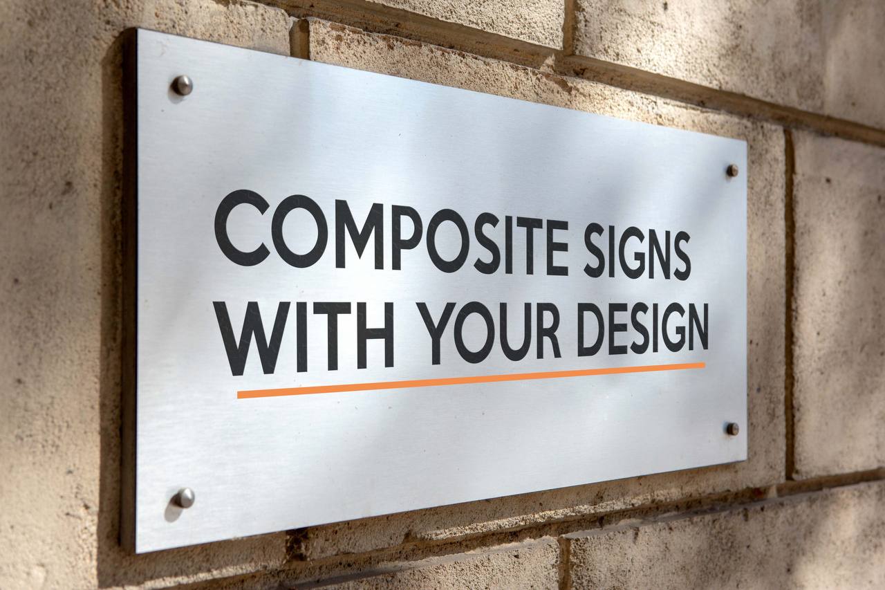 Composite sign with standoff fixings on a stone wall